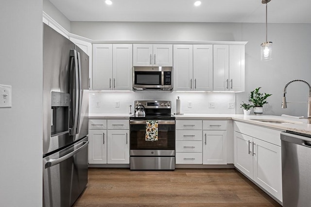 3302 Briarwood Vlg Unit 3302, Clinton, MA 01510 - kitchen featuring appliances with stainless steel finishes, light countertops, white cabinets, backsplash, and recessed lighting