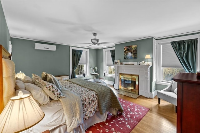 70 Hawthorn St, New Bedford, MA 02740 - bedroom featuring a wall mounted AC, wood finished floors, a tile fireplace, crown molding, and a ceiling fan