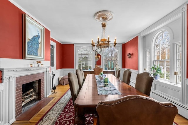70 Hawthorn St, New Bedford, MA 02740 - dining area featuring a chandelier, healthy amount of natural light, crown molding, light wood-style floors, and baseboard heating