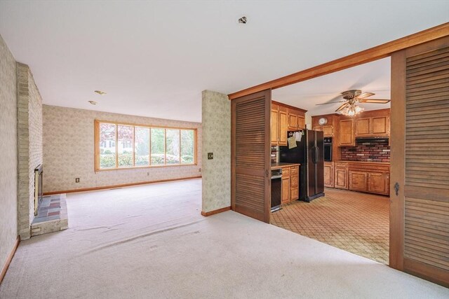 136 Butternut Hollow Rd, West Springfield, MA 01089 - kitchen with light colored carpet, black appliances, a ceiling fan, open floor plan, and brown cabinets
