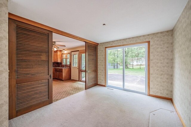 136 Butternut Hollow Rd, West Springfield, MA 01089 - unfurnished living room featuring wallpapered walls, a sink, baseboards, light colored carpet, and a ceiling fan