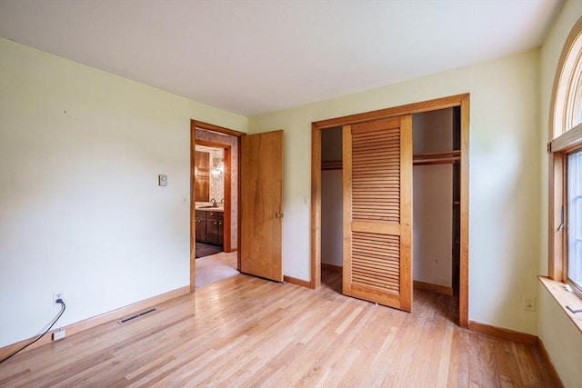 136 Butternut Hollow Rd, West Springfield, MA 01089 - unfurnished bedroom featuring a closet, light wood-style flooring, and baseboards