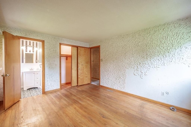 136 Butternut Hollow Rd, West Springfield, MA 01089 - unfurnished bedroom featuring light wood-type flooring, a sink, a closet, and baseboards