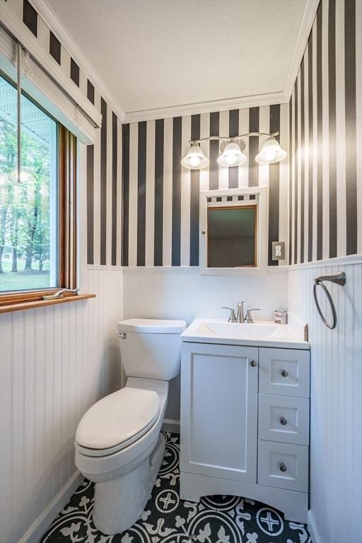 136 Butternut Hollow Rd, West Springfield, MA 01089 - bathroom featuring wallpapered walls, toilet, a wainscoted wall, vanity, and tile patterned floors