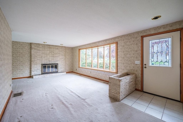 136 Butternut Hollow Rd, West Springfield, MA 01089 - unfurnished living room with wallpapered walls, a brick fireplace, baseboards, and tile patterned flooring