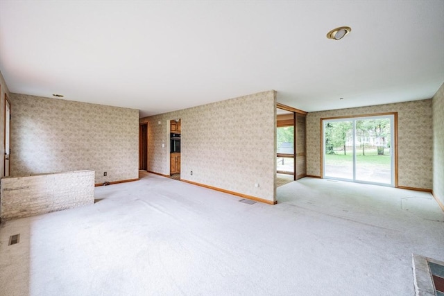 136 Butternut Hollow Rd, West Springfield, MA 01089 - unfurnished living room with wallpapered walls, carpet floors, and baseboards
