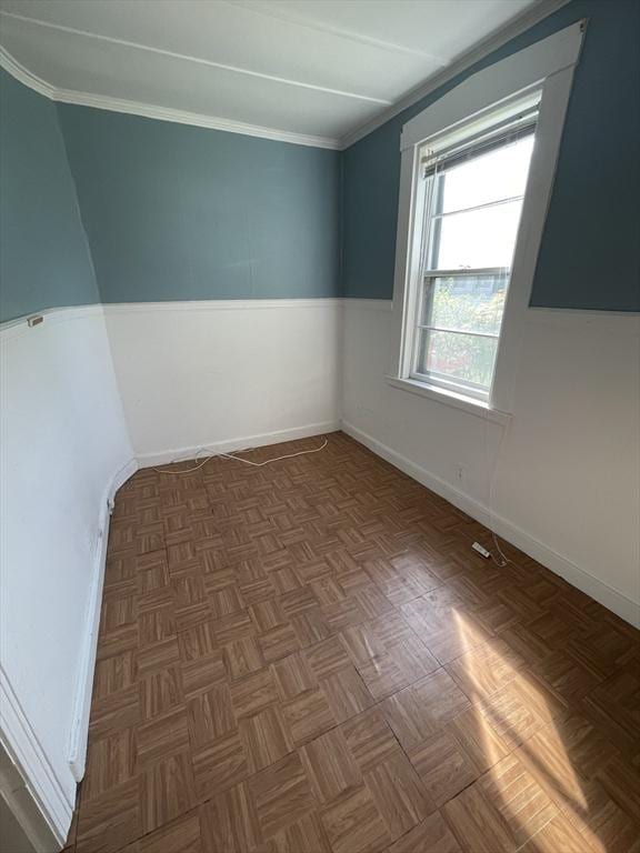 unfurnished room featuring crown molding