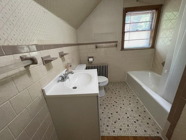 full bath with radiator, vanity, toilet, a bath, and wallpapered walls