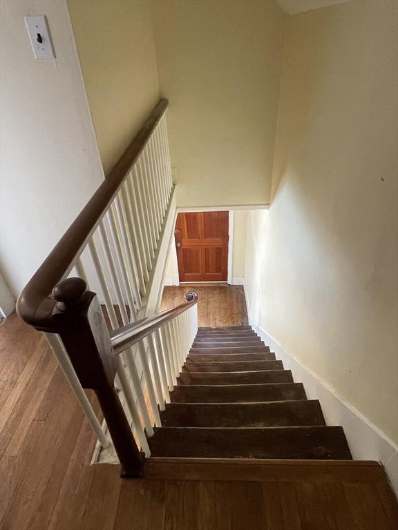 stairway featuring wood finished floors