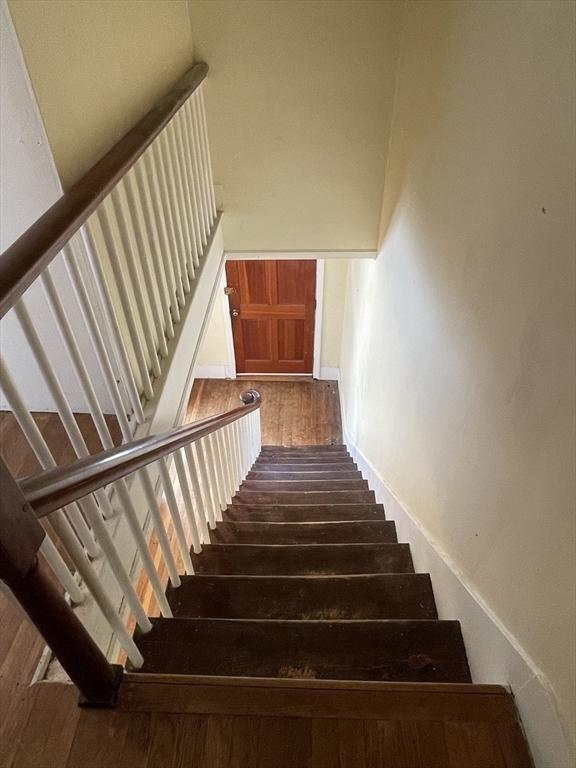 stairway featuring hardwood / wood-style flooring