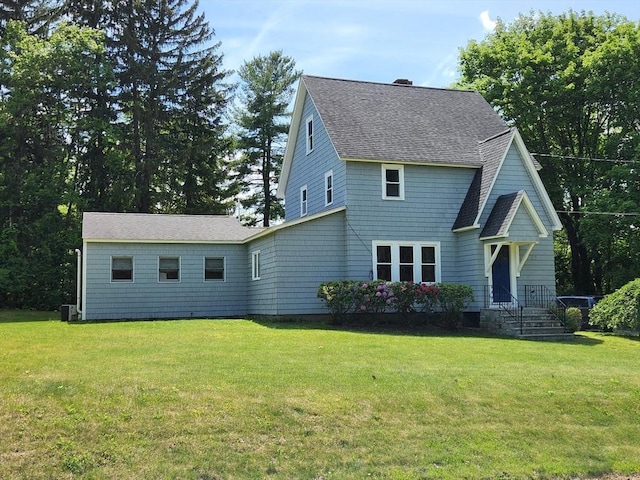 52 Walnut St, Shrewsbury, MA 01545 - view of front of home featuring roof with shingles, a front lawn, and cooling unit