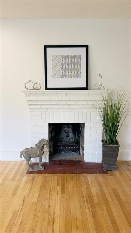 52 Walnut St, Shrewsbury, MA 01545 - detailed view of wood finished floors, baseboards, and a fireplace