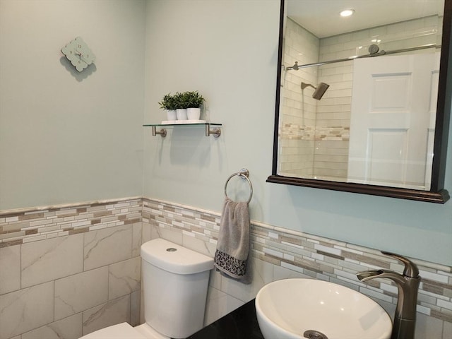 52 Walnut St, Shrewsbury, MA 01545 - bathroom featuring tile walls, a sink, toilet, a wainscoted wall, and a tile shower