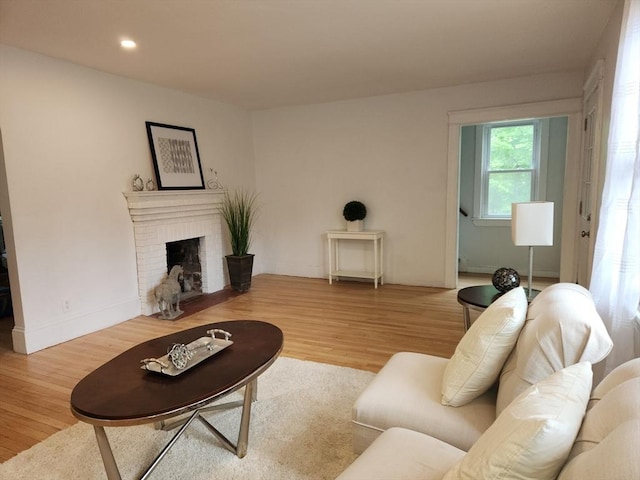52 Walnut St, Shrewsbury, MA 01545 - living area with wood finished floors, a brick fireplace, and recessed lighting