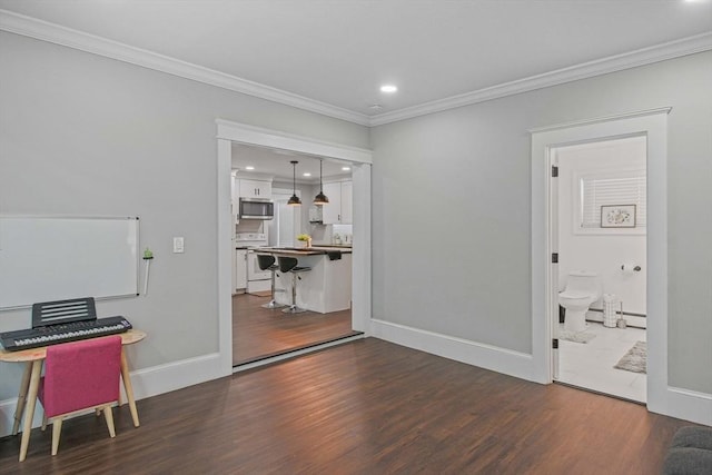 interior space with dark hardwood / wood-style flooring and ornamental molding