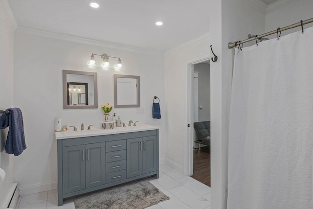 bathroom featuring baseboard heating, vanity, and crown molding