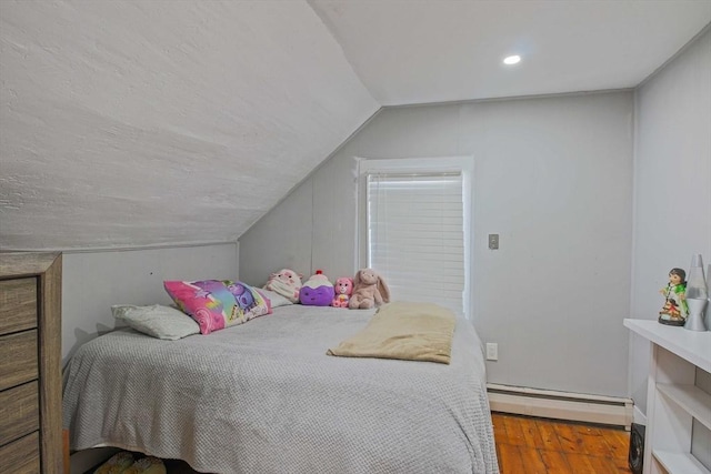 bedroom featuring lofted ceiling, hardwood / wood-style floors, and baseboard heating