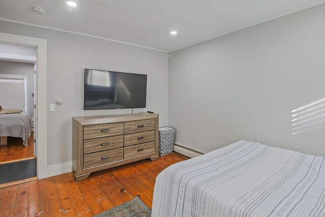 bedroom featuring dark hardwood / wood-style floors and a baseboard radiator