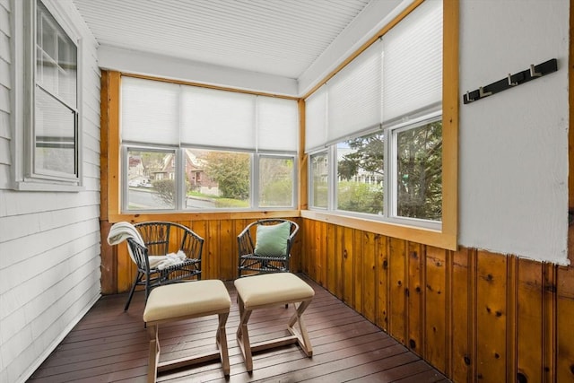 sunroom with wooden walls and hardwood / wood-style floors
