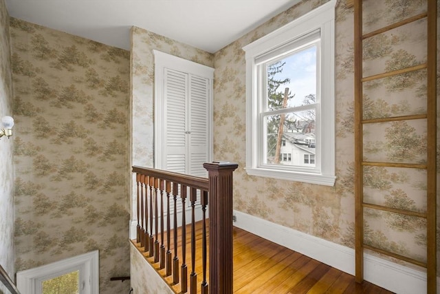 stairs featuring baseboards and hardwood / wood-style floors