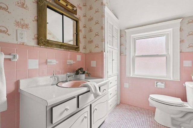 bathroom featuring toilet, wallpapered walls, tile walls, and tile patterned flooring