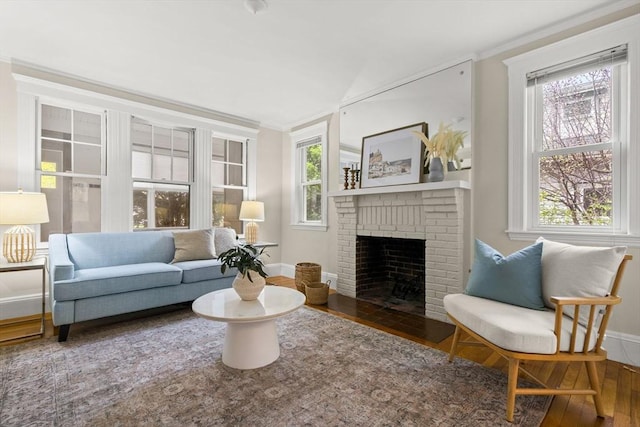 living room with baseboards, wood finished floors, a wealth of natural light, and a fireplace