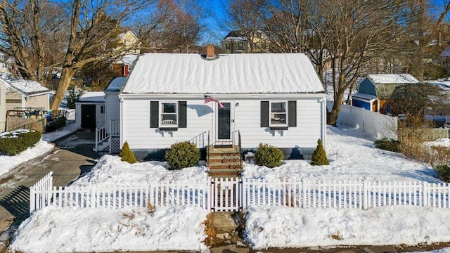 view of front of property with metal roof and a fenced front yard