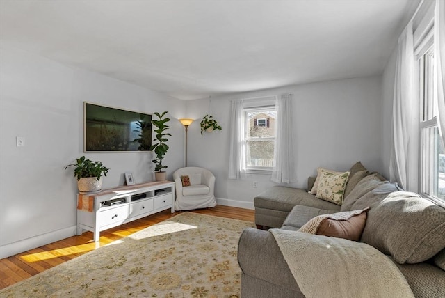 living room featuring light wood-style flooring and baseboards