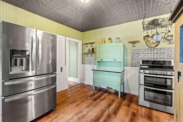 kitchen with wood-type flooring and stainless steel appliances