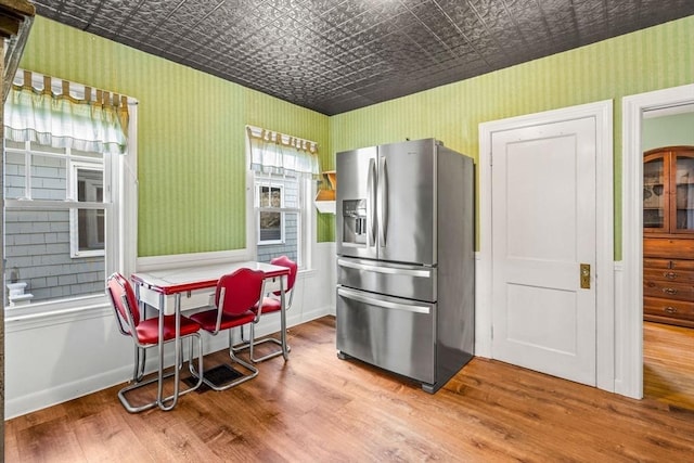 kitchen featuring hardwood / wood-style floors and stainless steel refrigerator with ice dispenser