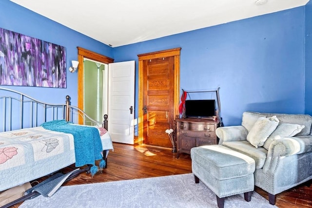 bedroom with hardwood / wood-style floors