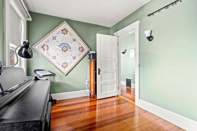 home office with hardwood / wood-style floors