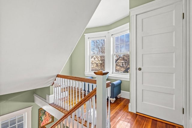 staircase with hardwood / wood-style flooring and vaulted ceiling