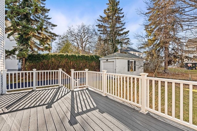 wooden deck with a garage and an outdoor structure