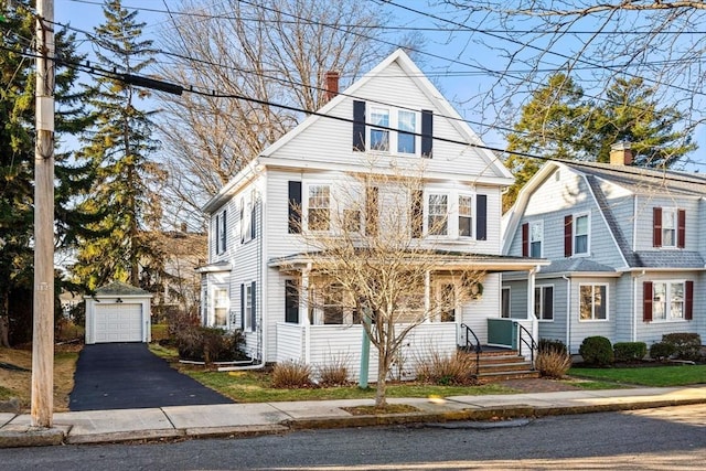 view of front property with a garage and an outdoor structure