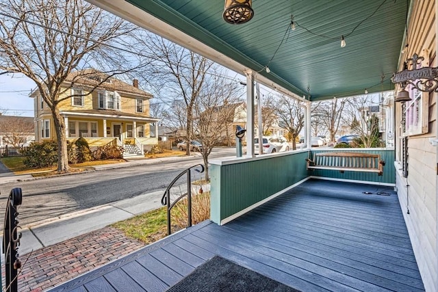 wooden terrace with a porch