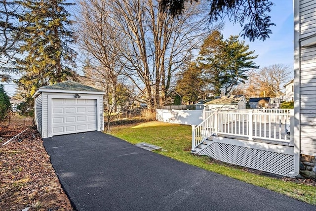 view of yard with a garage, an outdoor structure, and a deck