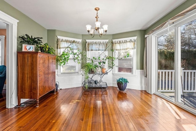 interior space with hardwood / wood-style floors and an inviting chandelier