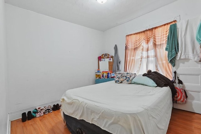 bedroom with wood-type flooring