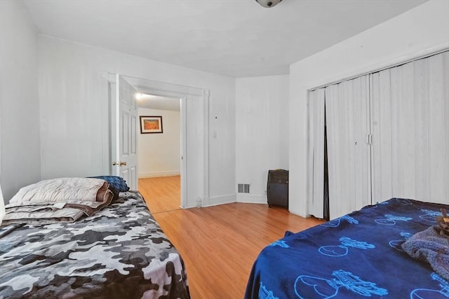 bedroom featuring hardwood / wood-style flooring and a closet