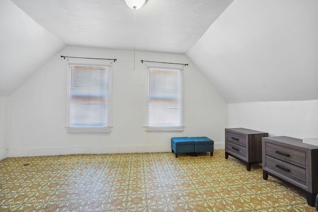 additional living space featuring lofted ceiling