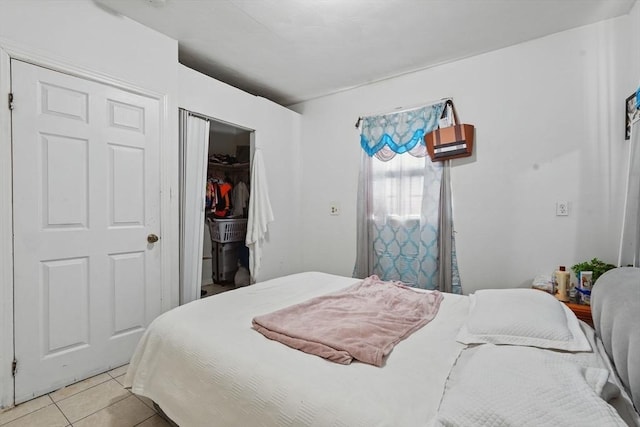 bedroom featuring a closet and light tile patterned flooring