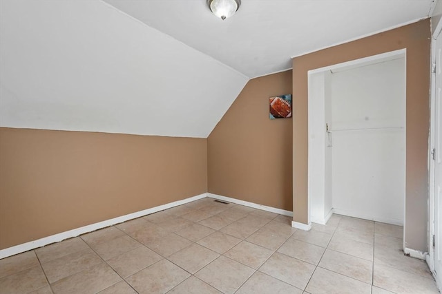 bonus room featuring light tile patterned floors and lofted ceiling