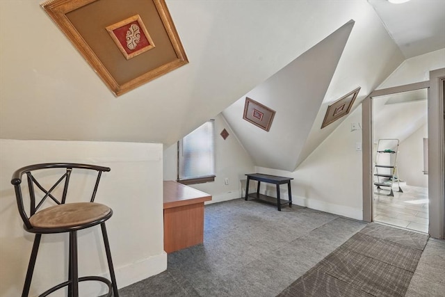 bonus room with carpet flooring and vaulted ceiling