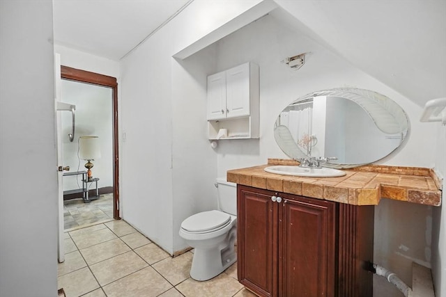 bathroom featuring tile patterned flooring, vanity, and toilet