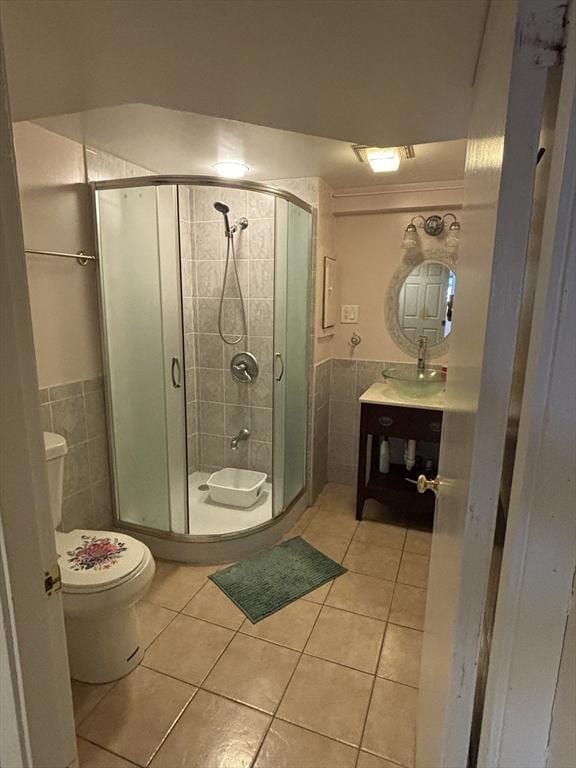 12 Inis Cir, Newton, MA 02465 - bathroom featuring toilet, tile patterned flooring, tile walls, a shower stall, and vanity