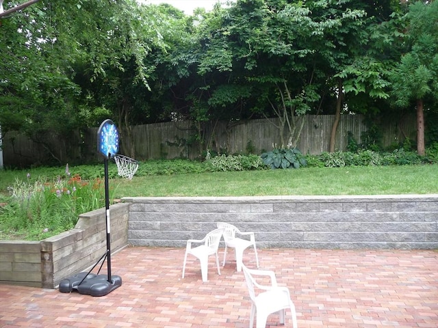 12 Inis Cir, Newton, MA 02465 - fenced backyard with a patio area