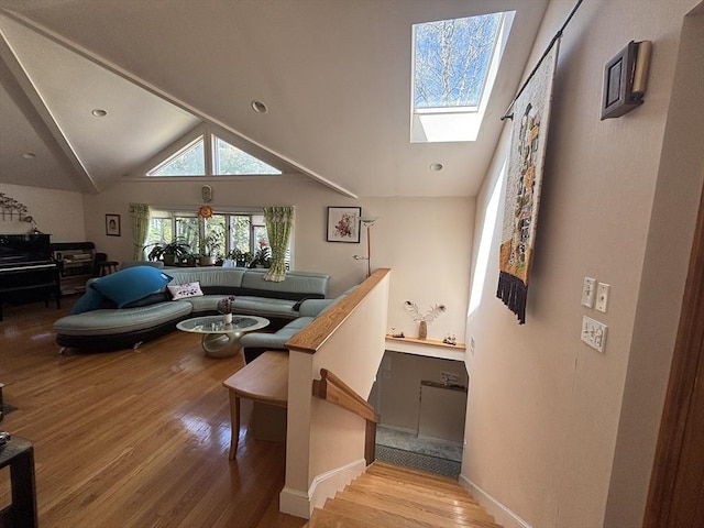 12 Inis Cir, Newton, MA 02465 - living area featuring a skylight, wood finished floors, vaulted ceiling, and baseboards