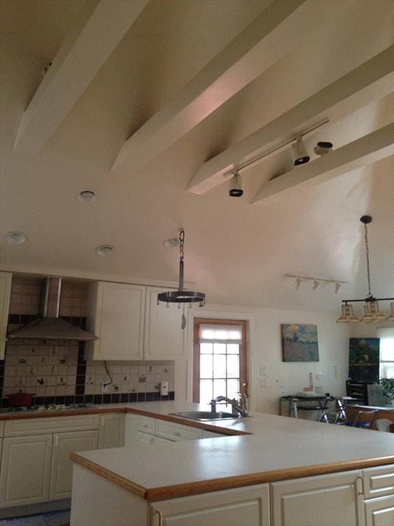 12 Inis Cir, Newton, MA 02465 - kitchen featuring wall chimney exhaust hood, a sink, white gas cooktop, backsplash, and white cabinetry