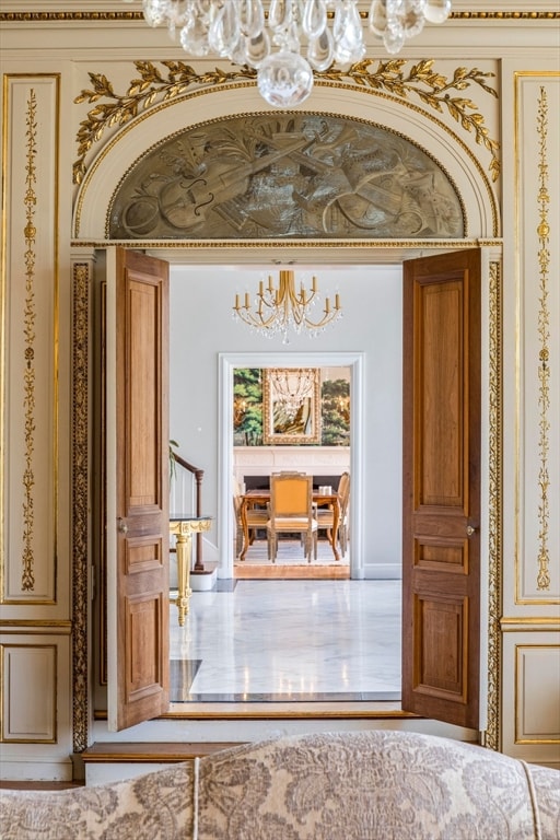 hall featuring a notable chandelier